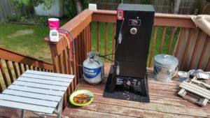 The "operation". Chips soaking, nice aluminum table for prep/holding while opening the door. Metal trashcan for ashes.